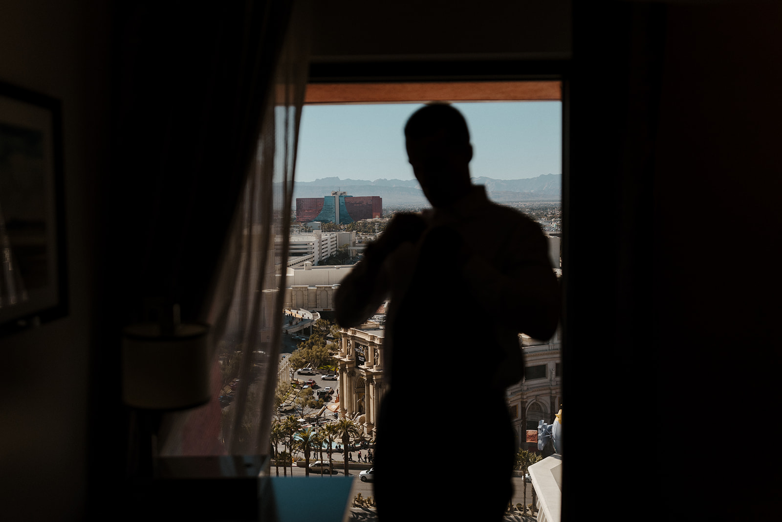 groom getting ready with vegas strip focused in background