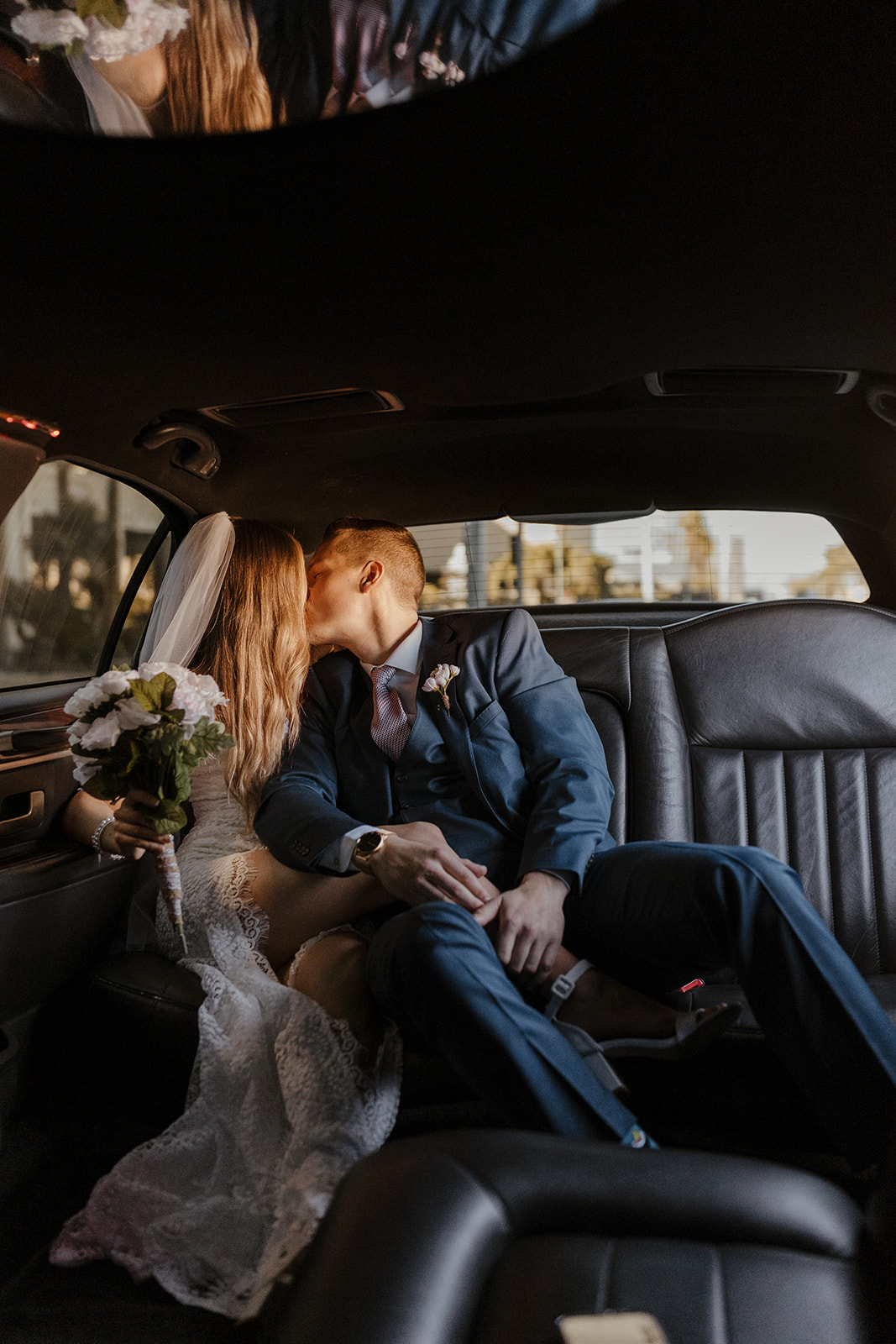 bridal couple kissing in limo