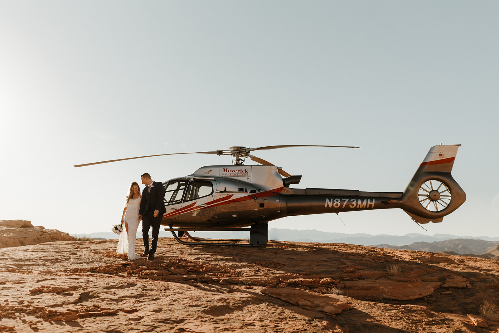 couple getting off helicopter in valley of fire