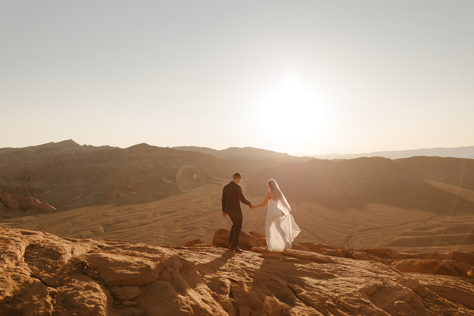 bridal couple in valley of fire peak at sunset
