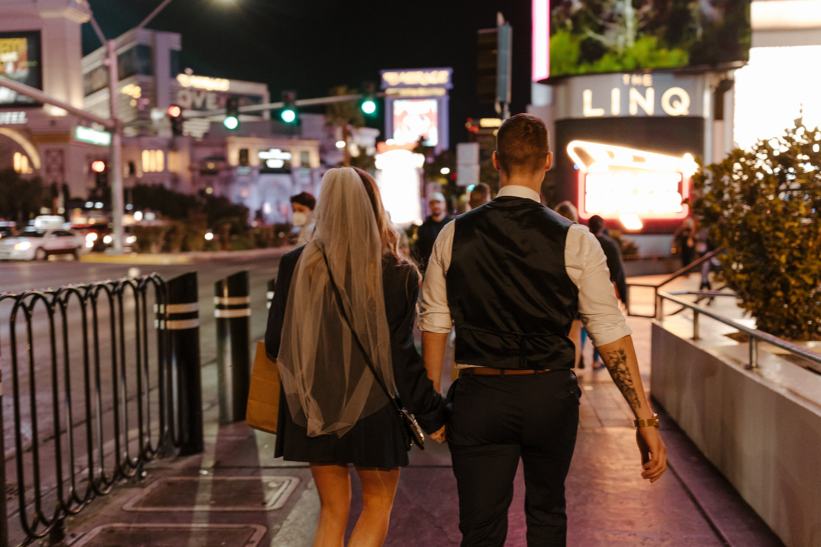 bridal couple walking on the strip