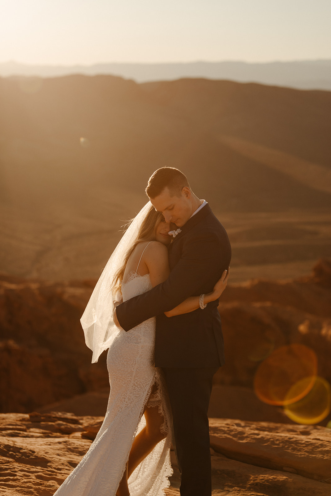 bride and groom hugging sunset photo