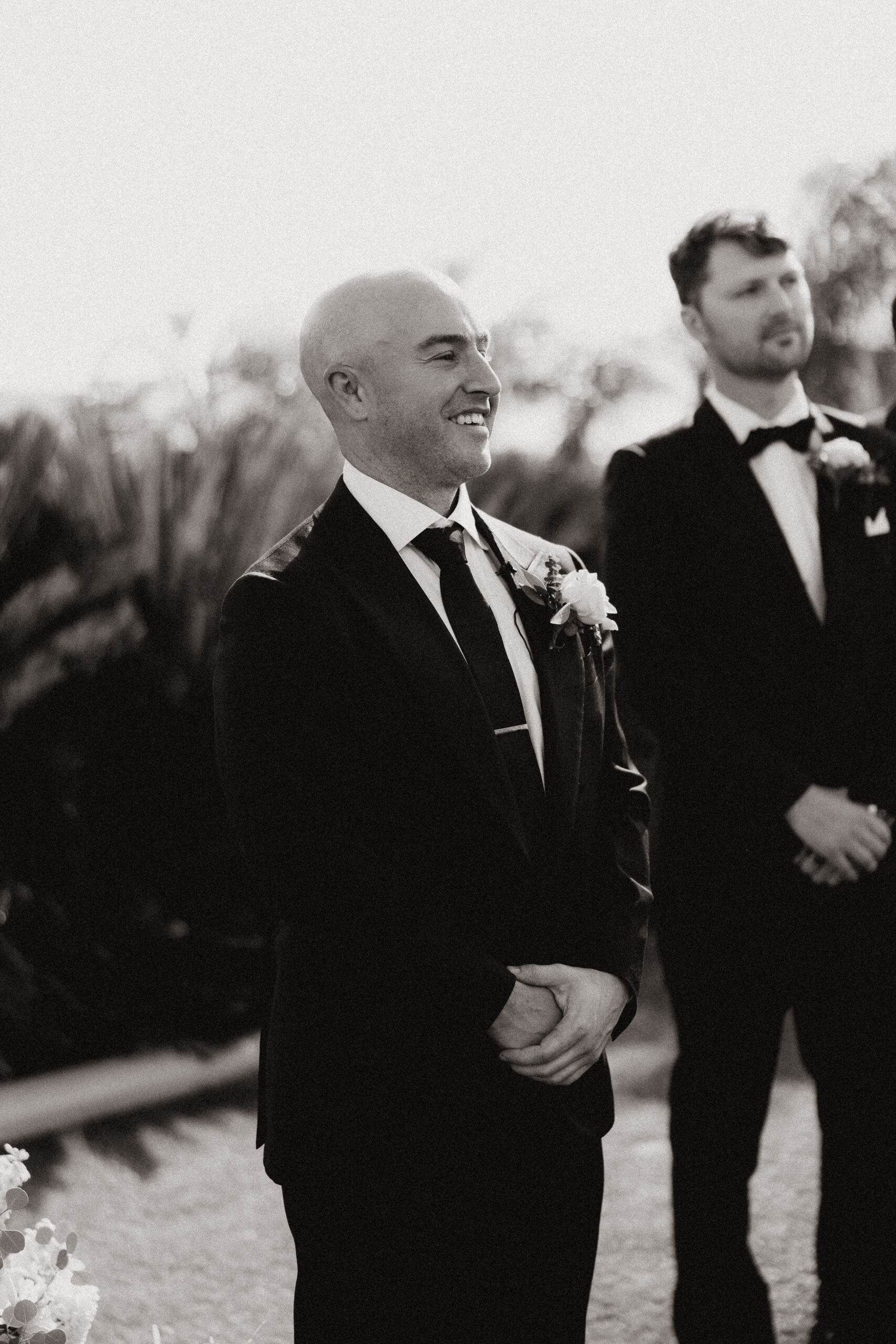black and white groom seeing bride at altar