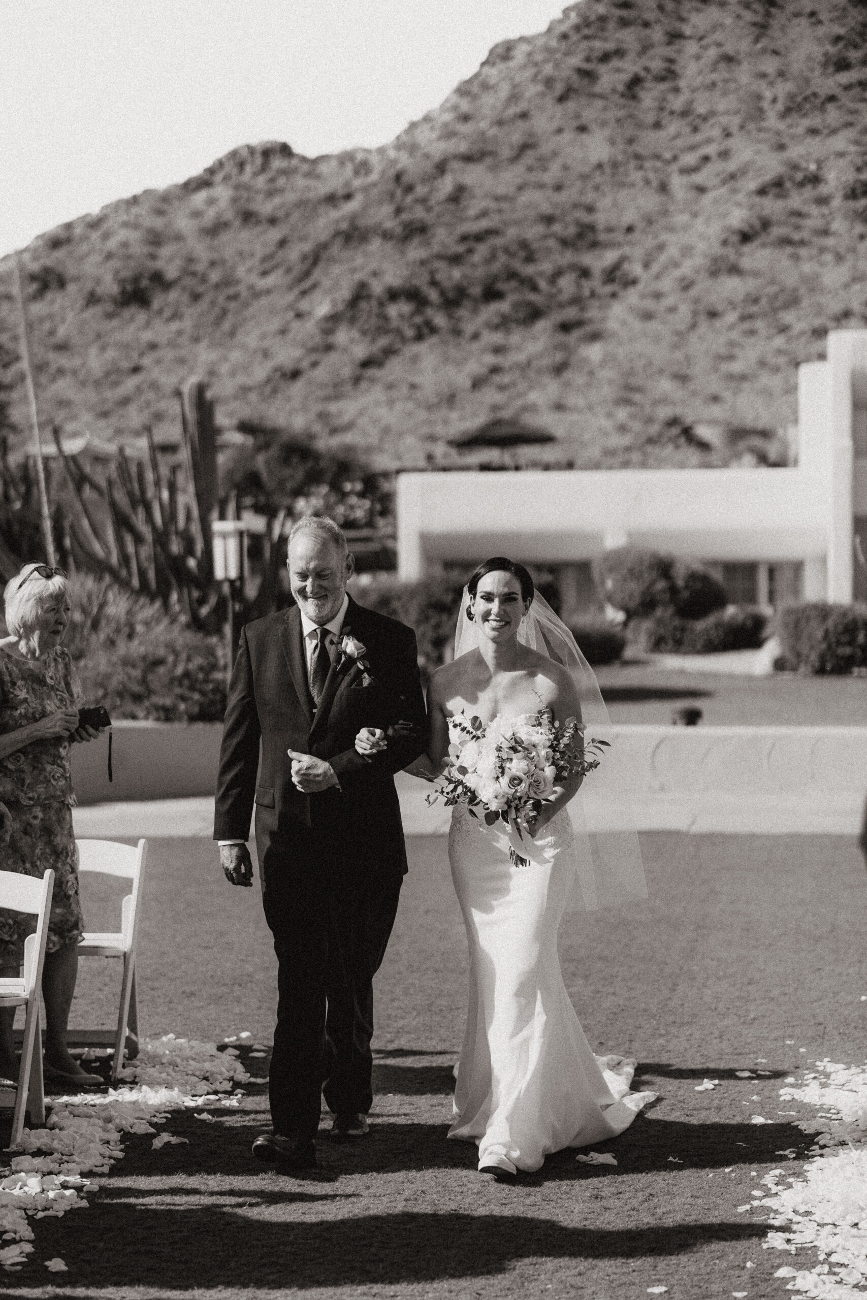 black and white father and bride walking down aisle