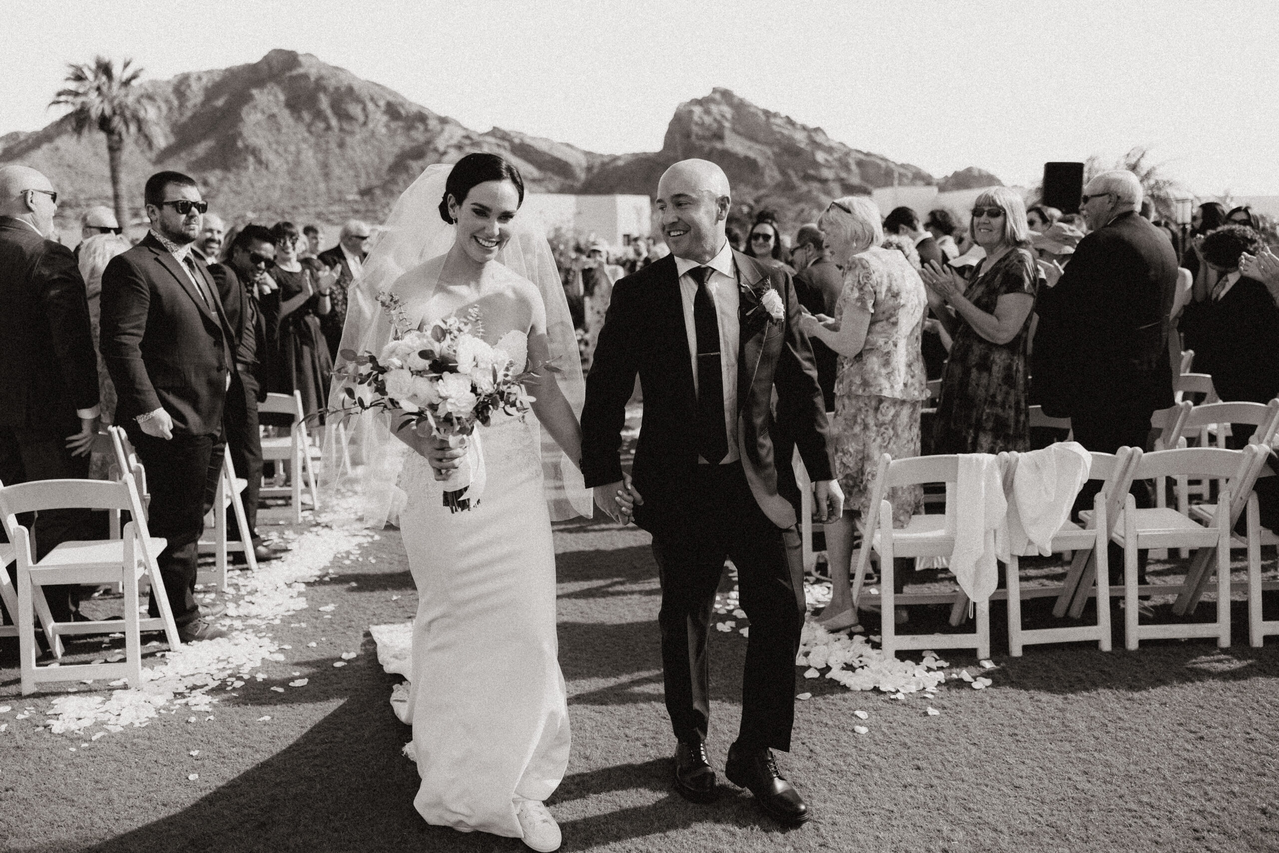 black and white bride and groom walking down aisle 
