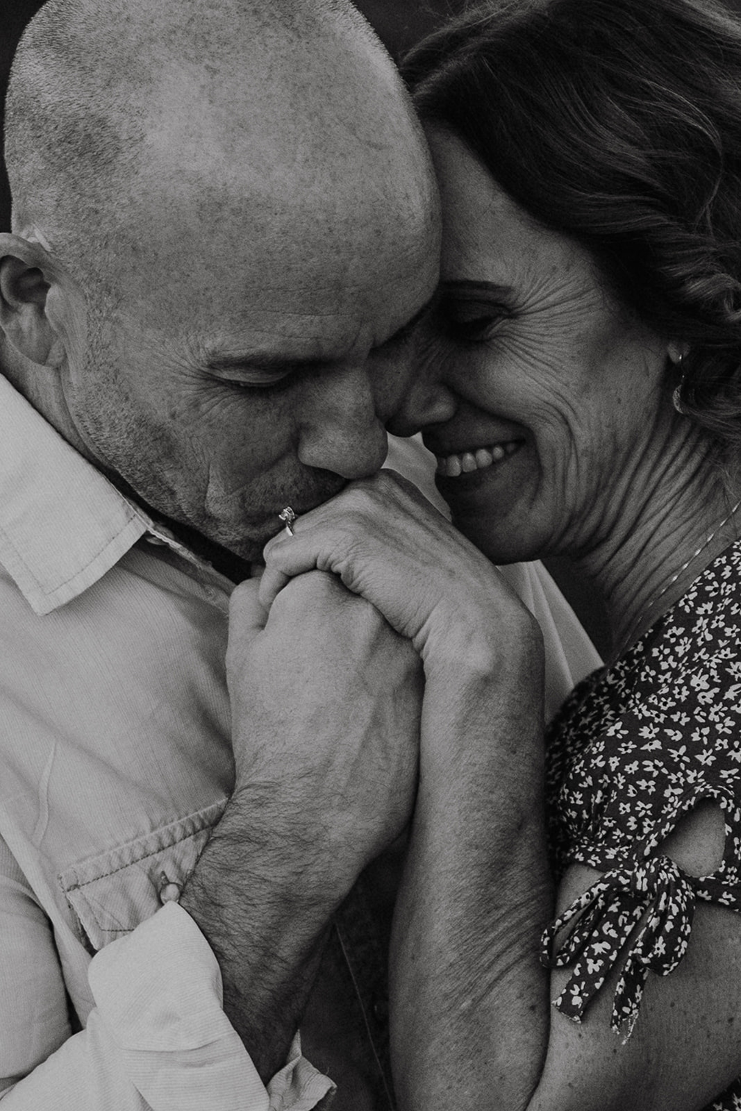 black and white closeup of david kissing michelle's hand