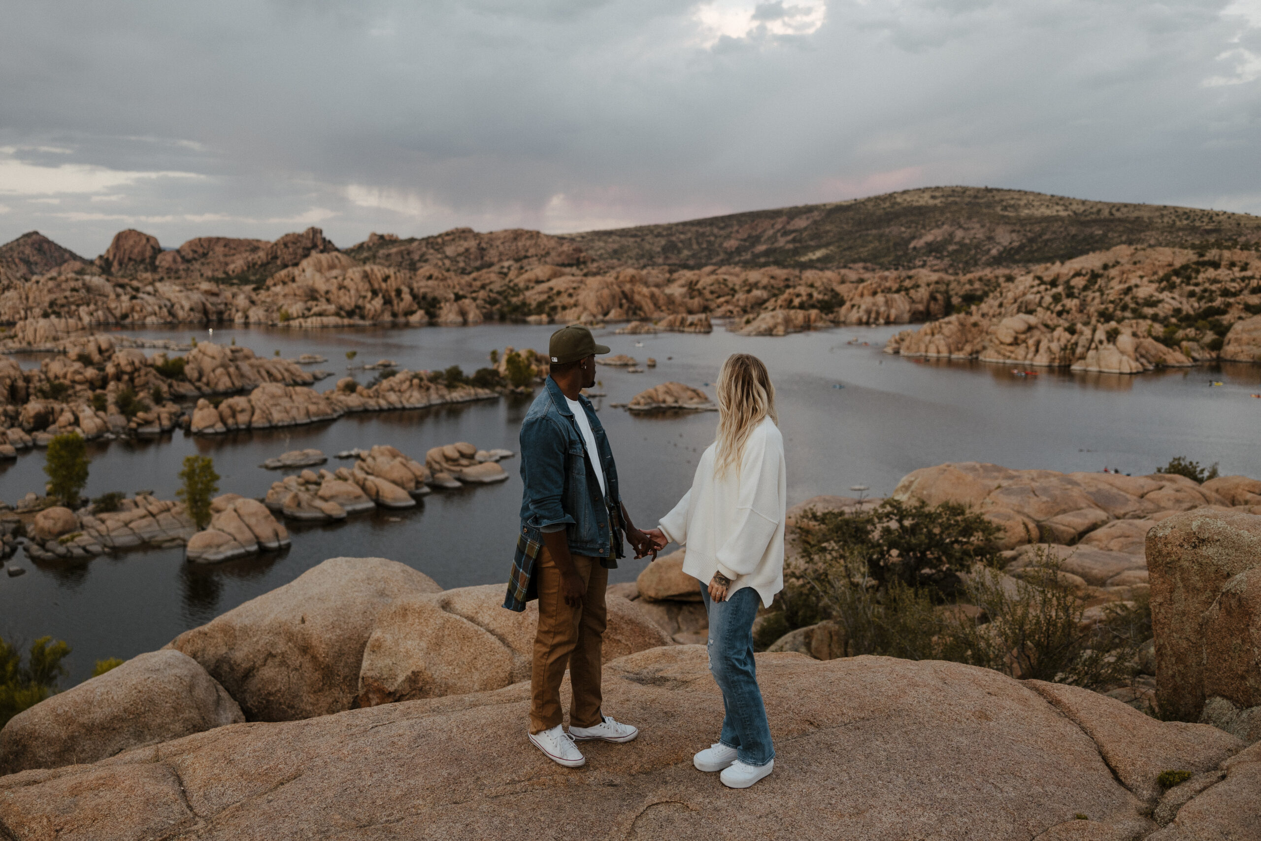 couple standing at watson lake in Arizona with rocks and lake in background 