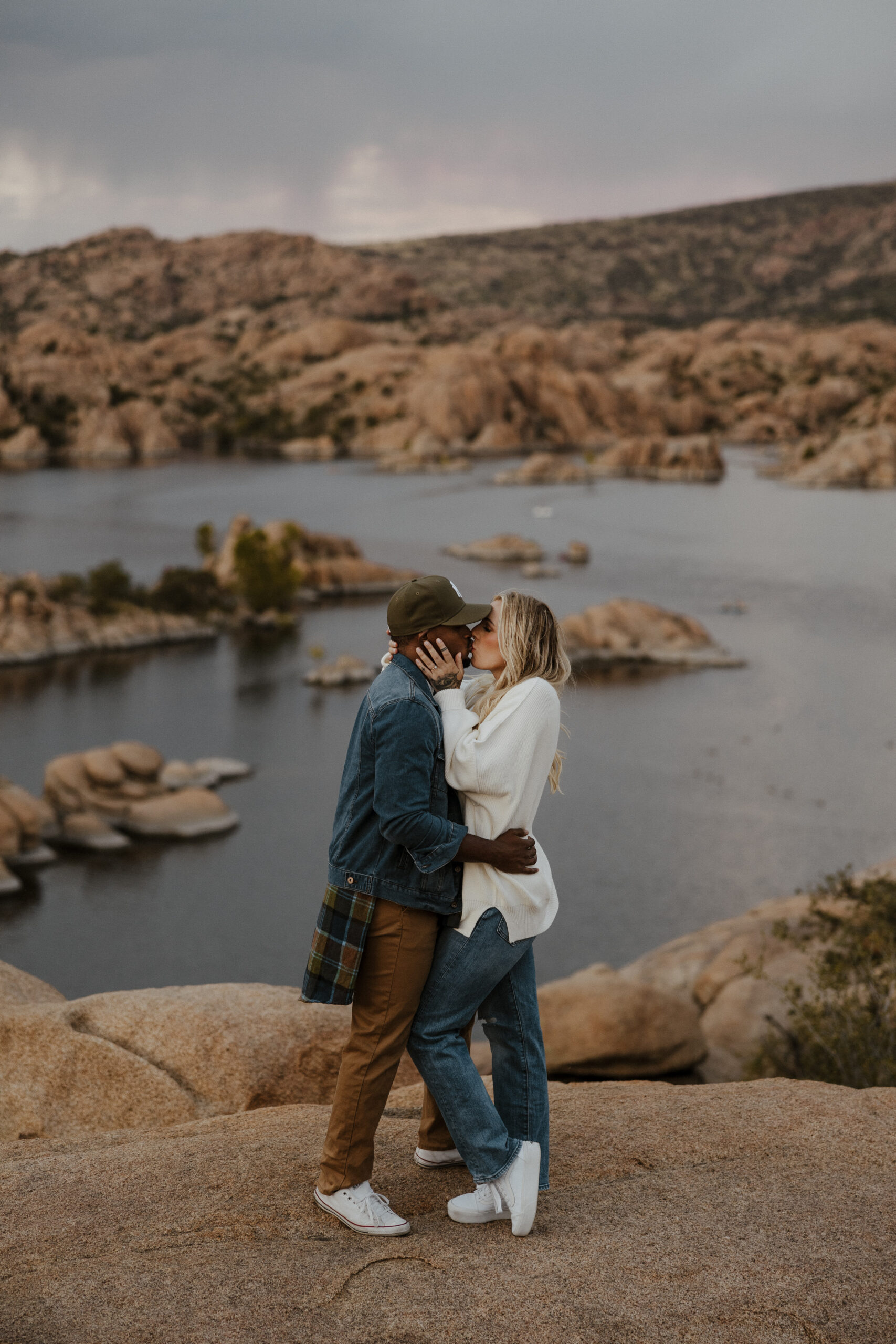 couple kissing with scenery in background