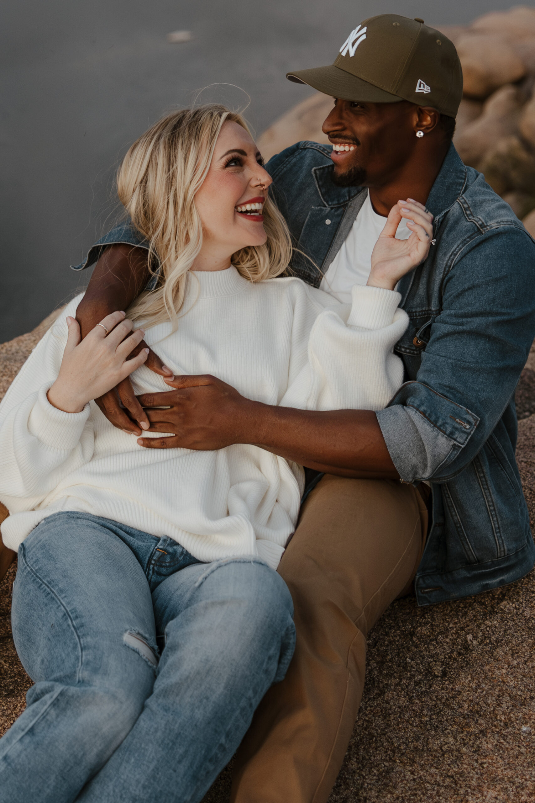 close up of couple laughing and holding each other 