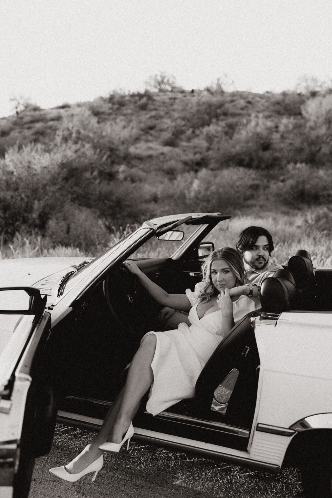 black and white of couple sitting in the car