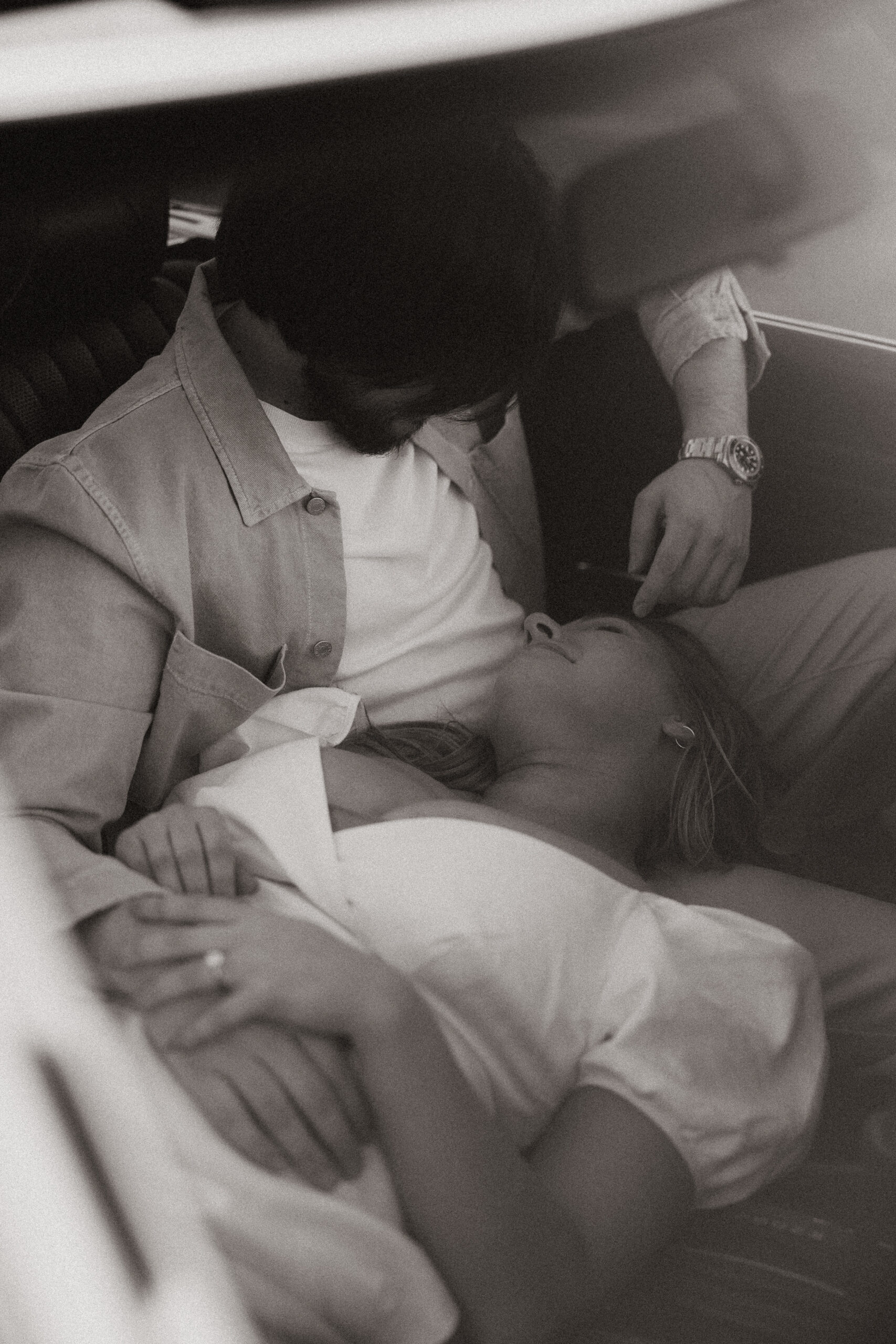 fiances laying her head in fiances lap for vintage car engagement photos 