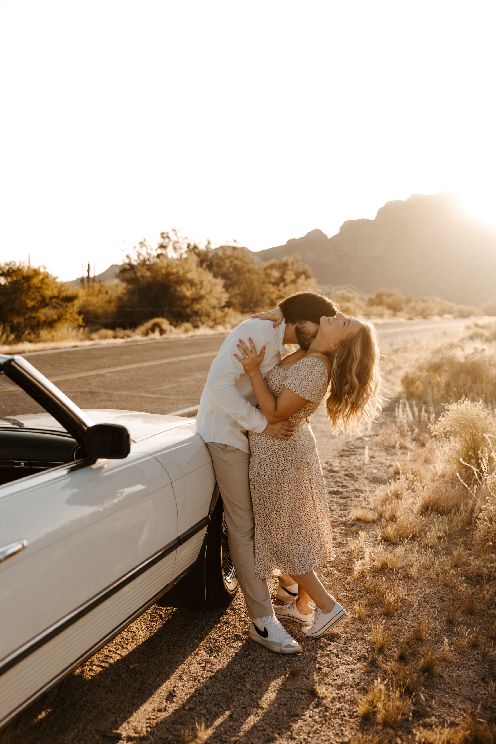 fiance kissing fiances neck for vintage car engagement photos 