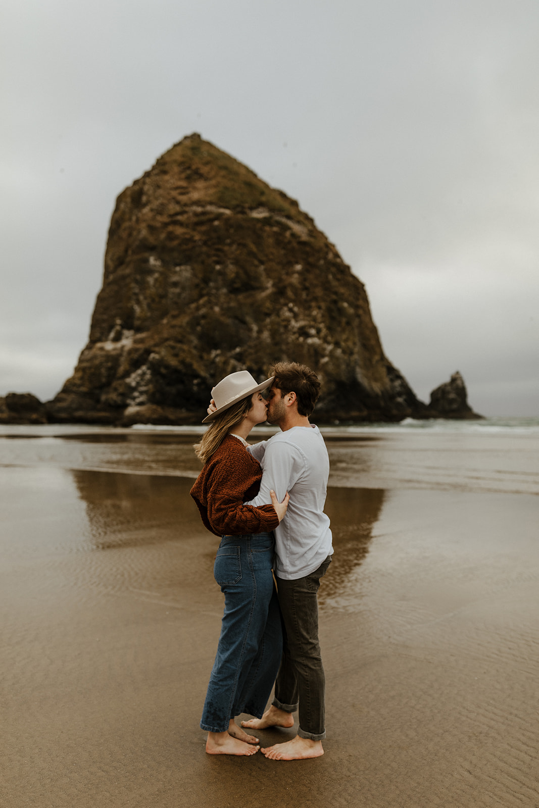 cannon beach engagement with haystack rock in the background