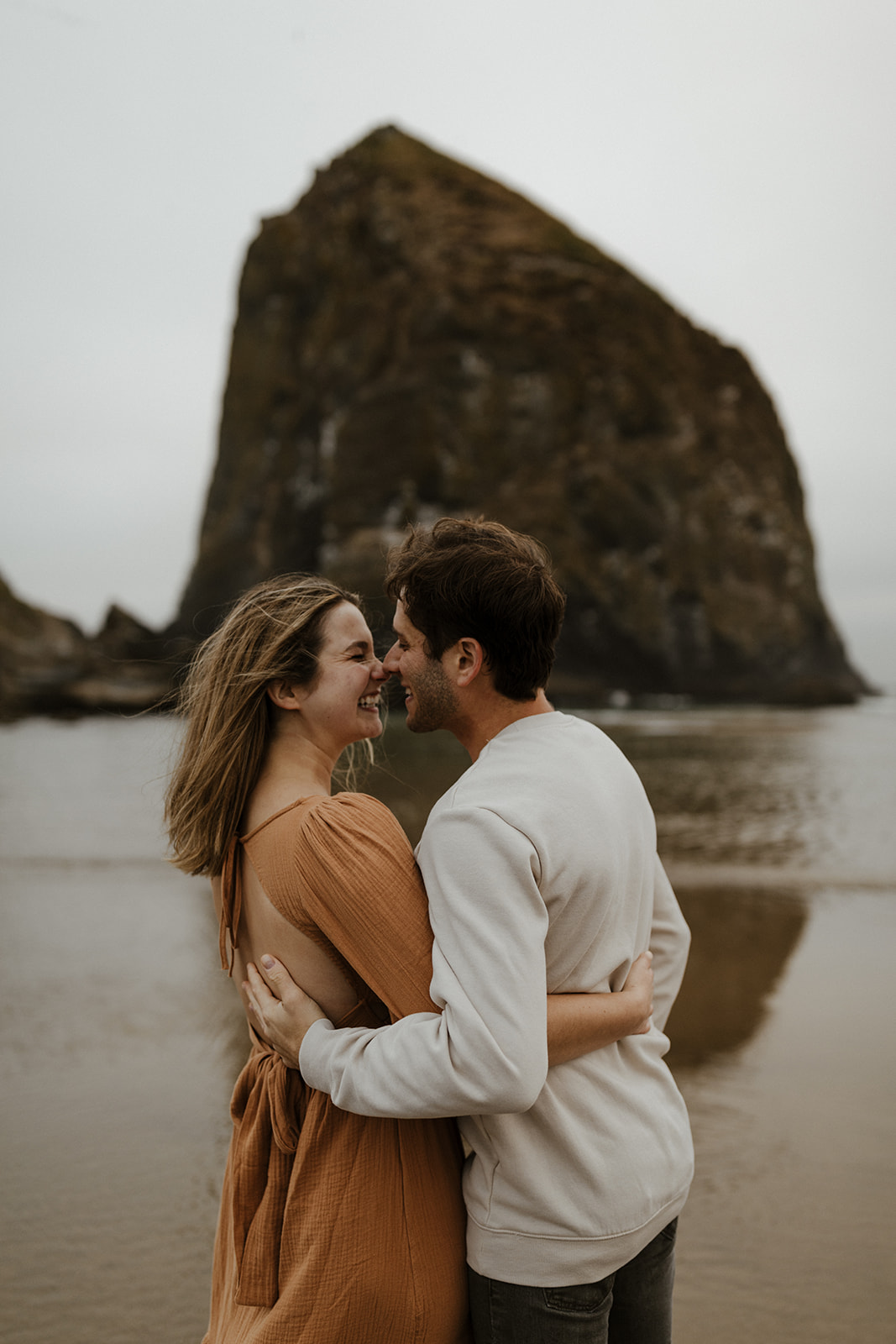 cannon beach engagement with haystack rock in the background