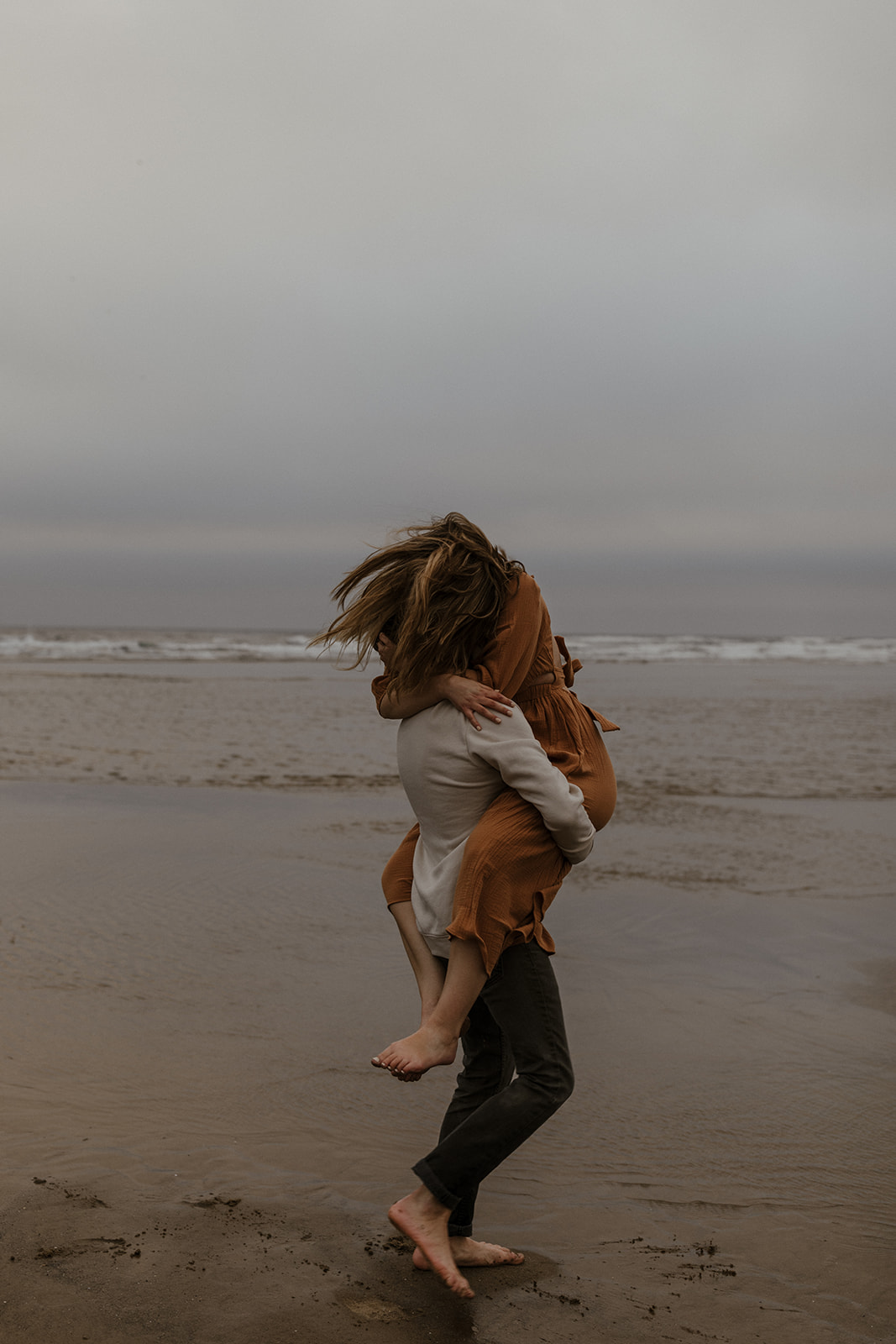 couple hugging on beach 