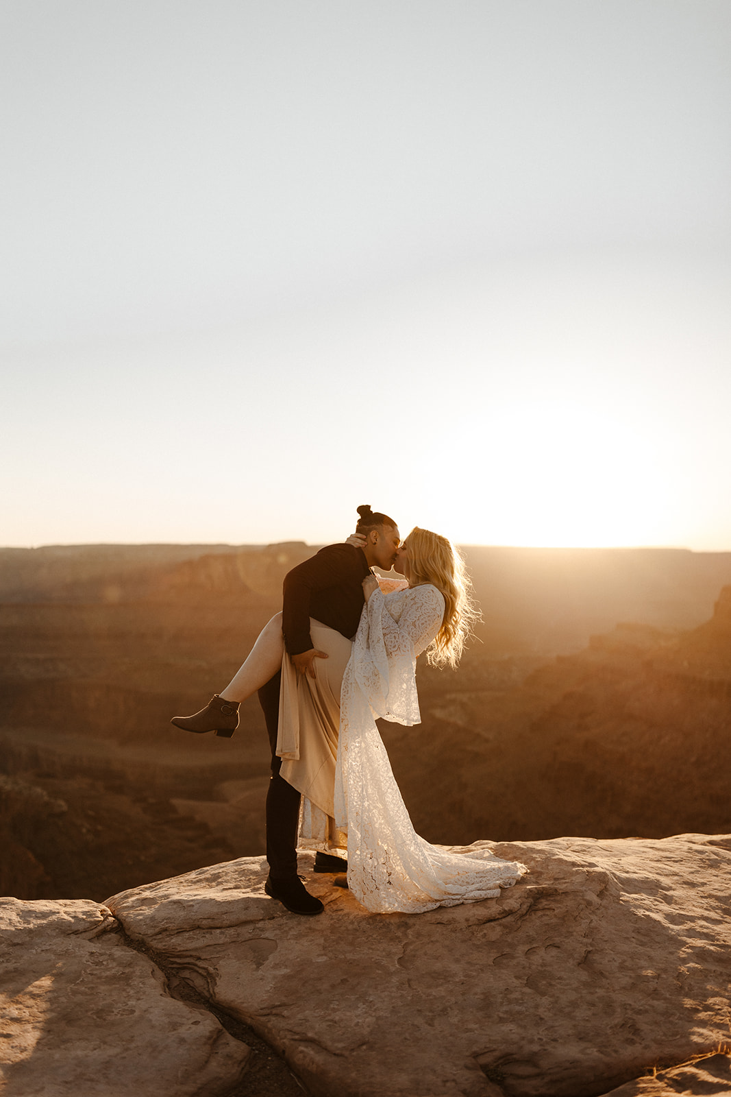 bridal couple at moab elopement with scenery in background