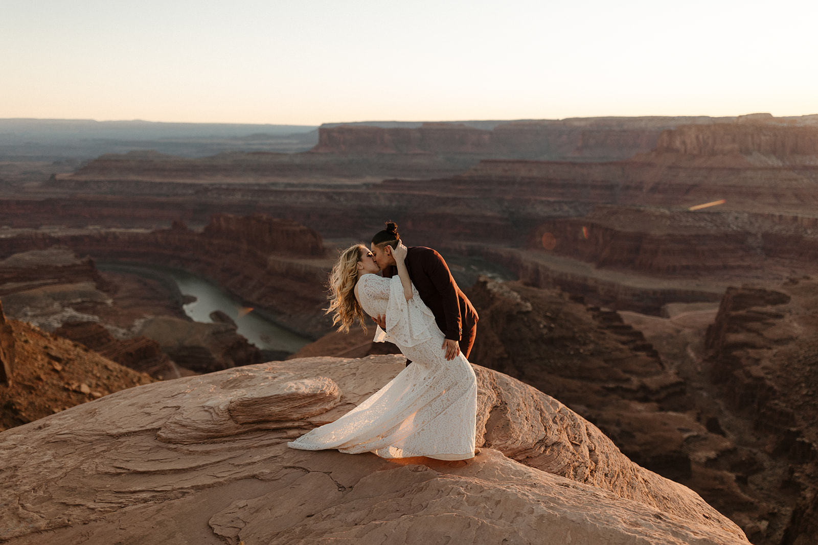 bridal couple at moab elopement with scenery in background
