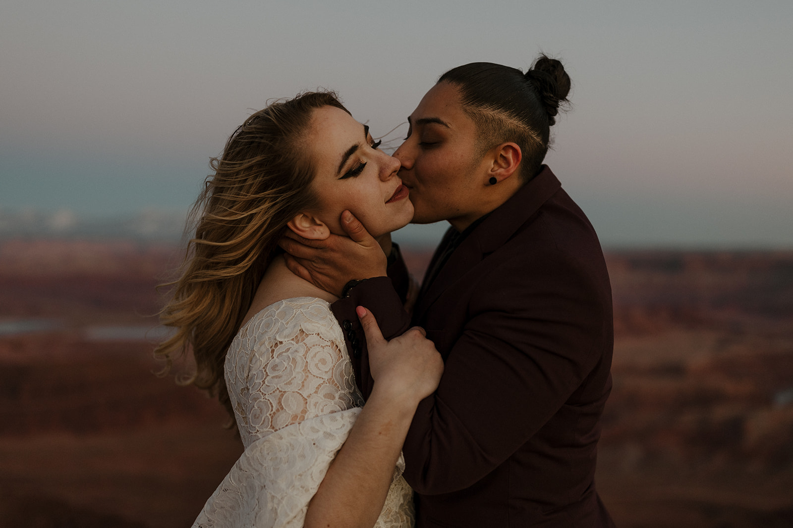 bridal couple kissing on cheek