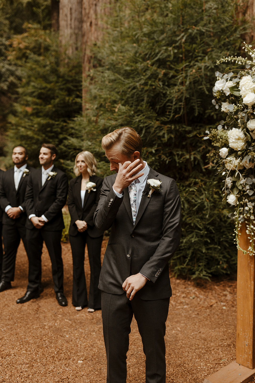 groom tearing up at altar