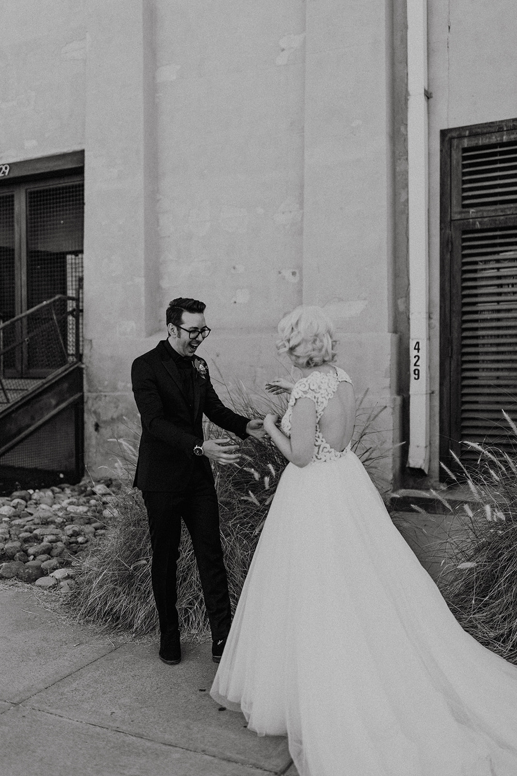black and white of grooms emotions as he sees bride for the first time