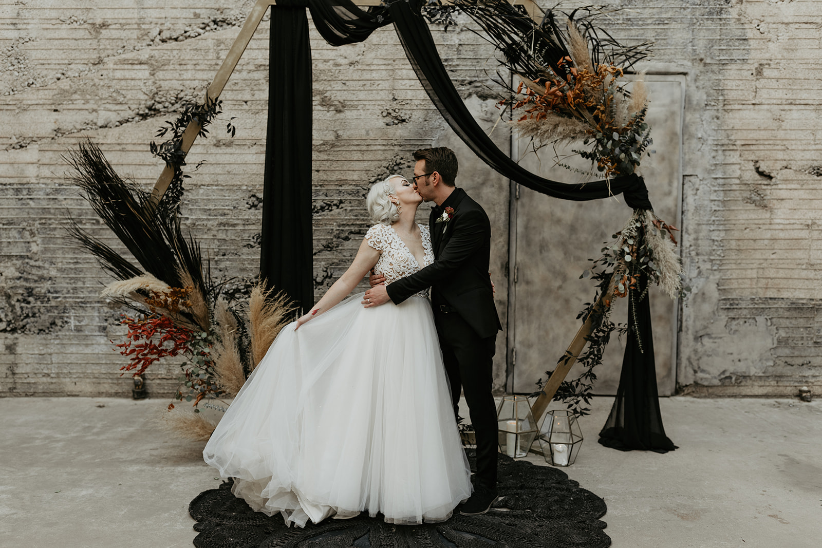bridal couple kissing at portrait at the altar 