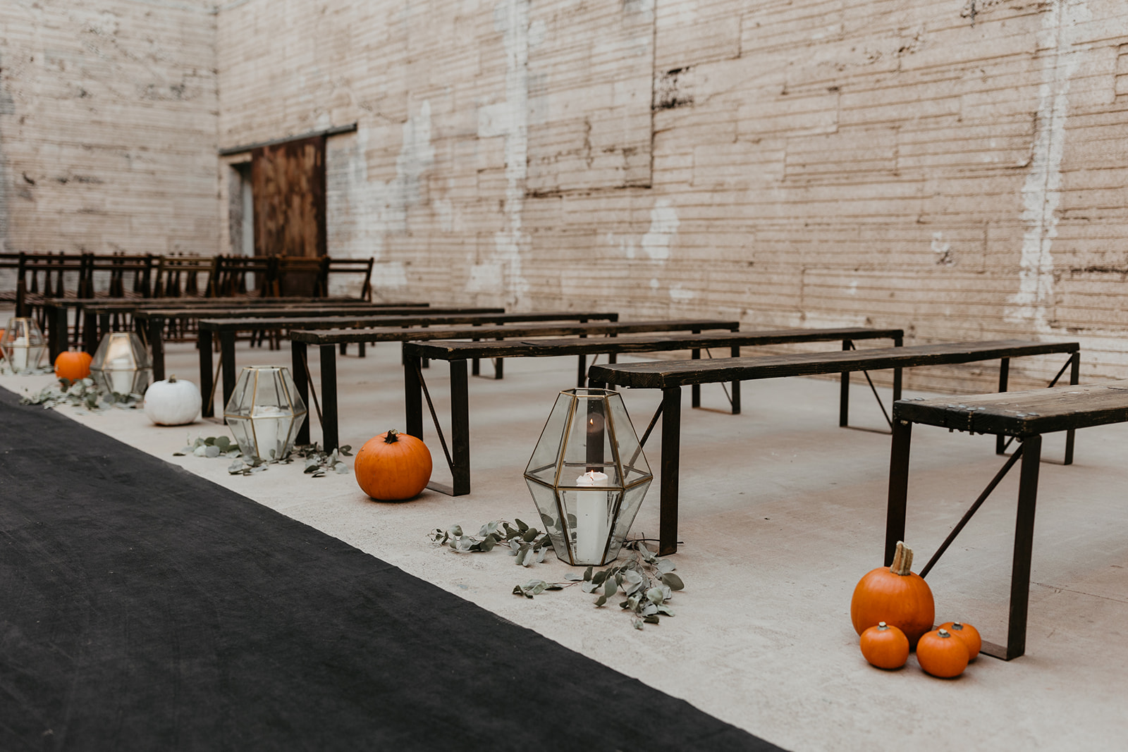 pumpkins and candles decorating the ceremony aisle at fall halloween wedding 
