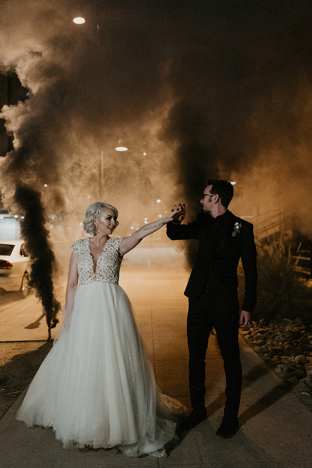 bridal couple portrait with black smoke bombs going off behind them 