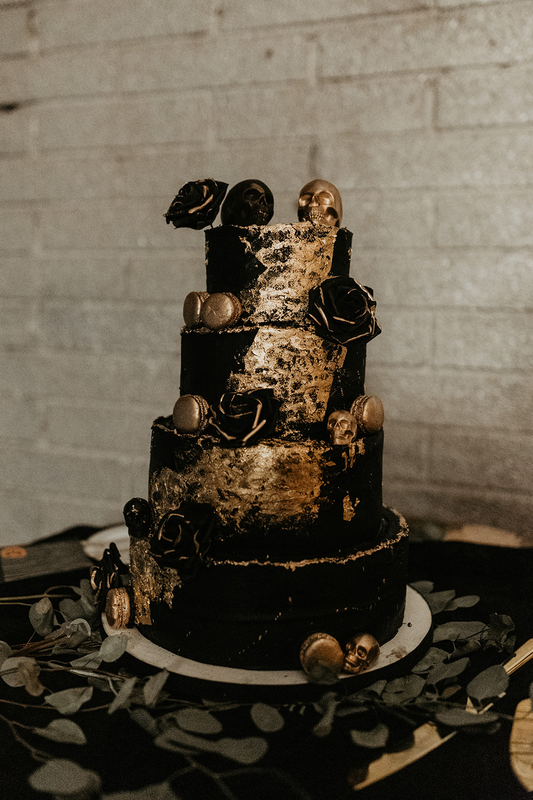 black and gold wedding cake with skulls 