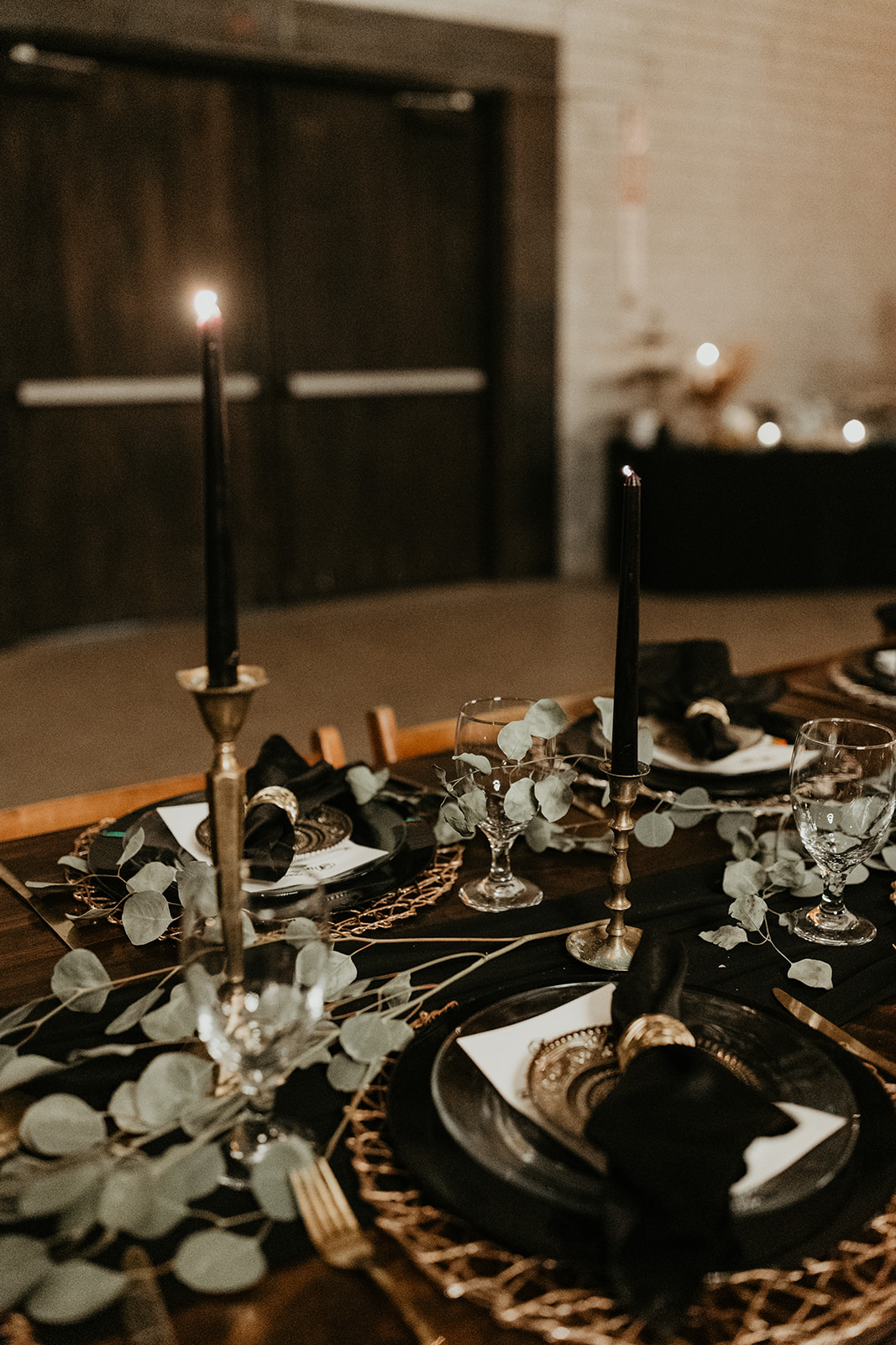black, gold and greenery decorating the reception tables 
