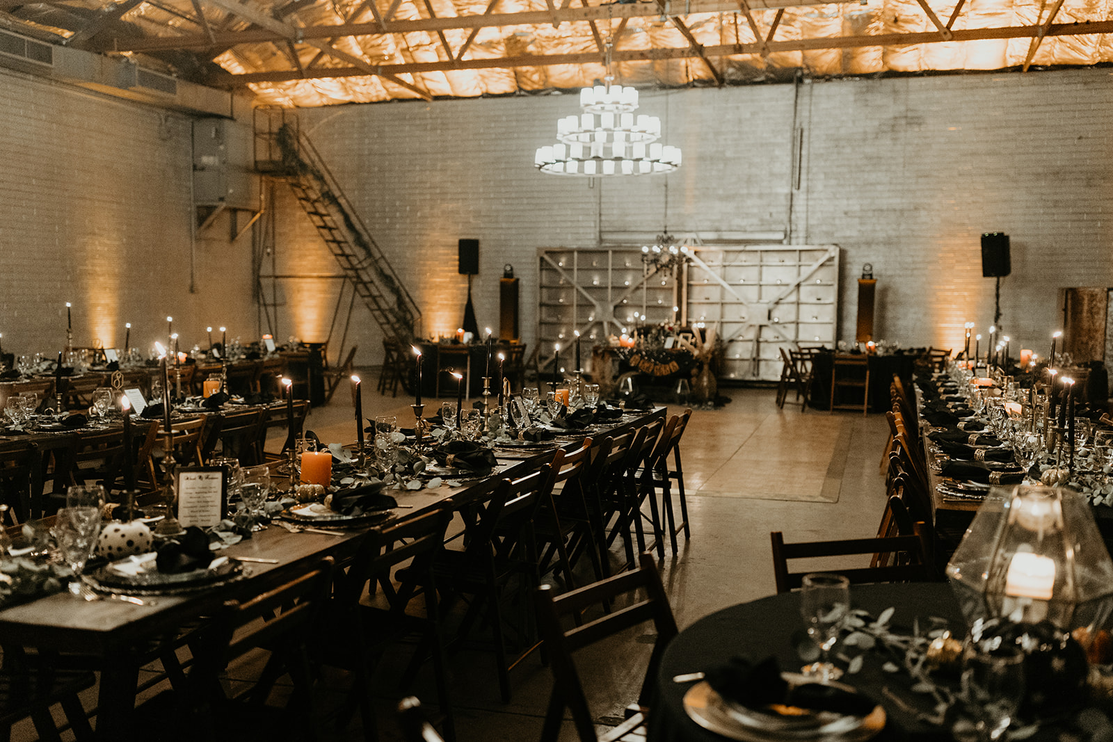 spooky and moody decorated reception space at fall halloween wedding 