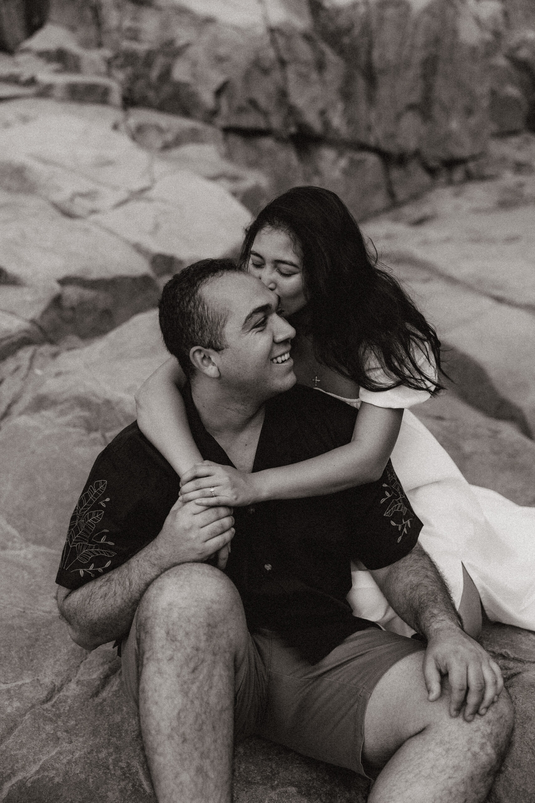 black and white of engaged couple holding each other at waterfall engagement photos