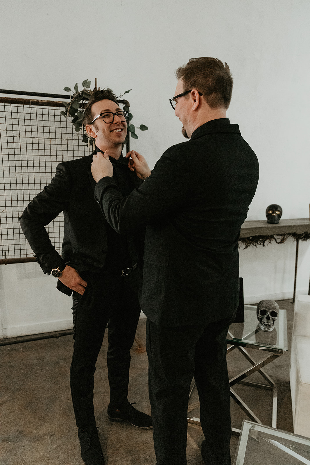 groom getting help with his tie 