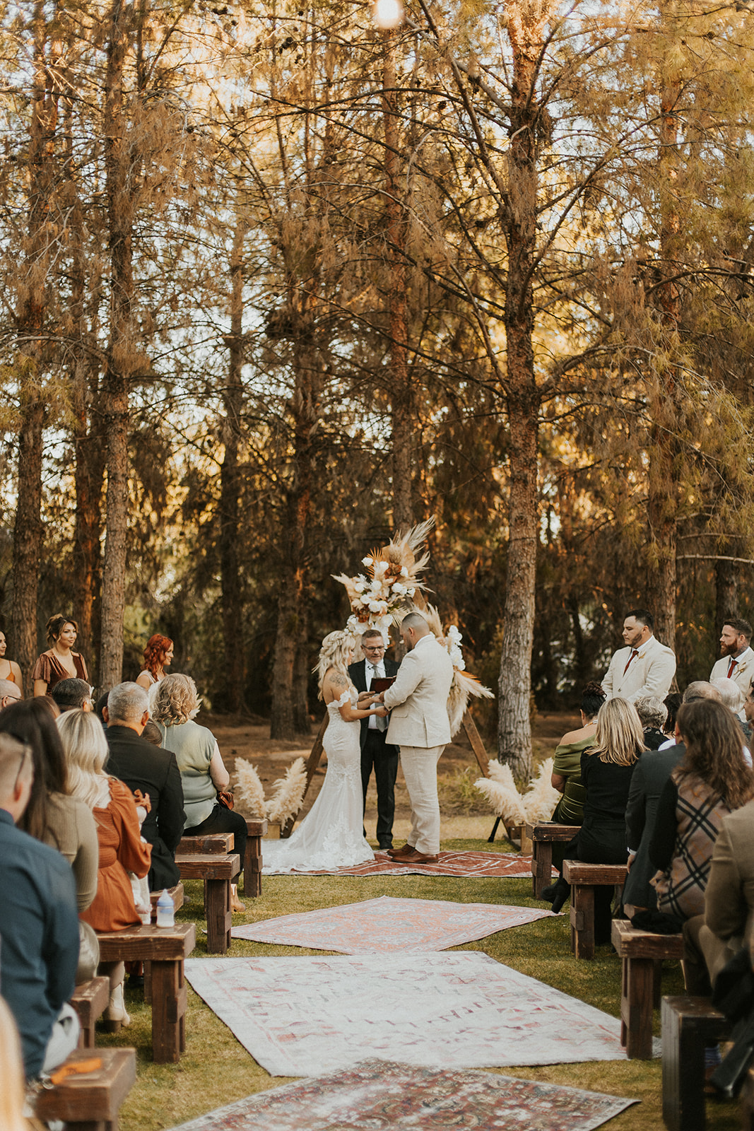 bridal couple at boho ceremony altar at one of Arizona's forest wedding venues