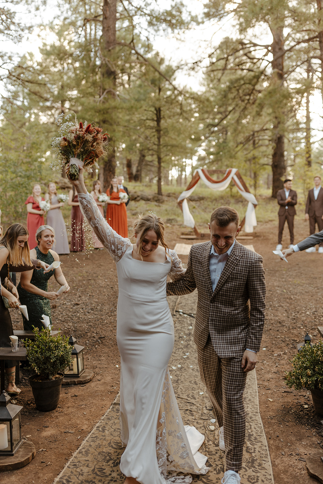 bridal couple walking down aisle at one of Arizona's forest wedding venues