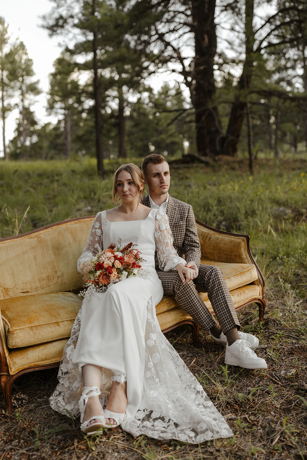 bride and groom portrait on a vintage couch in the woods