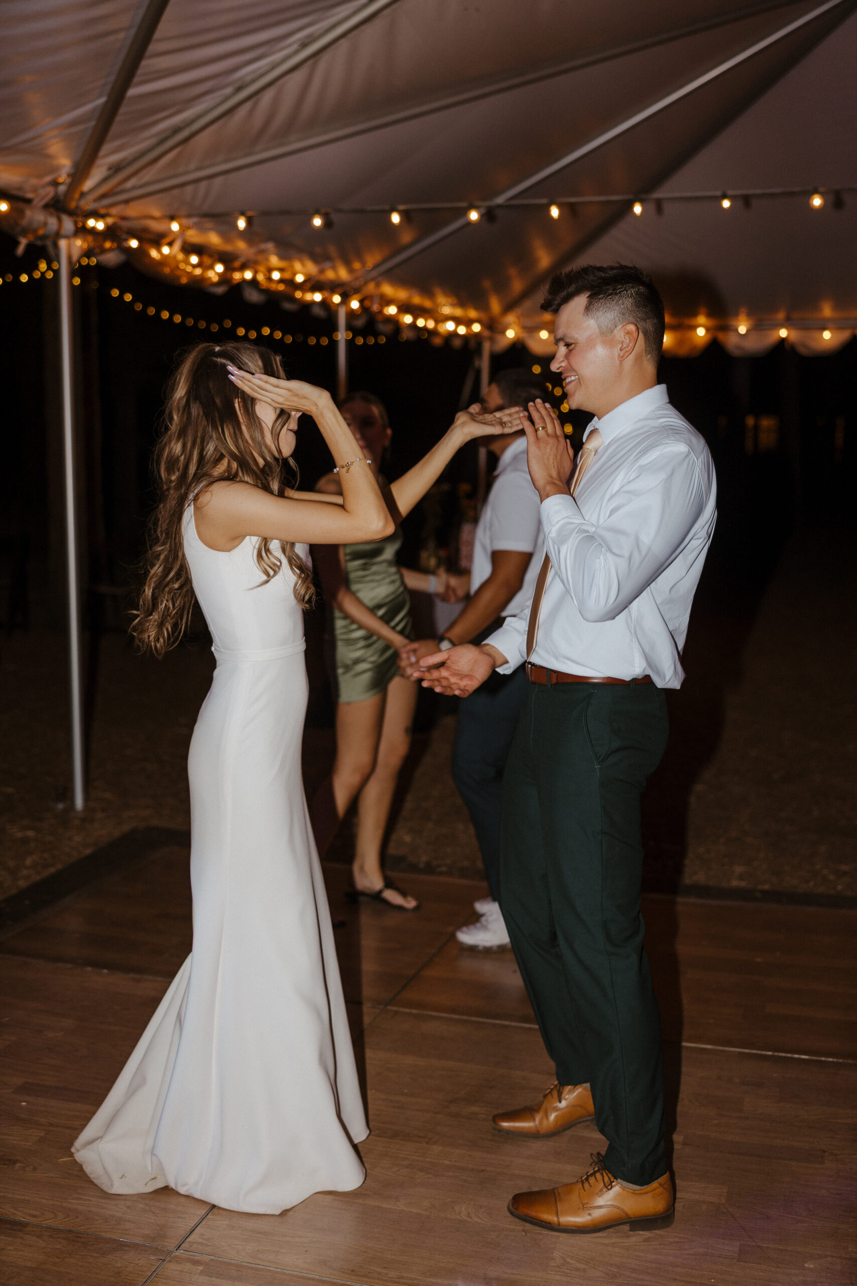 bride and groom dancing at tented reception