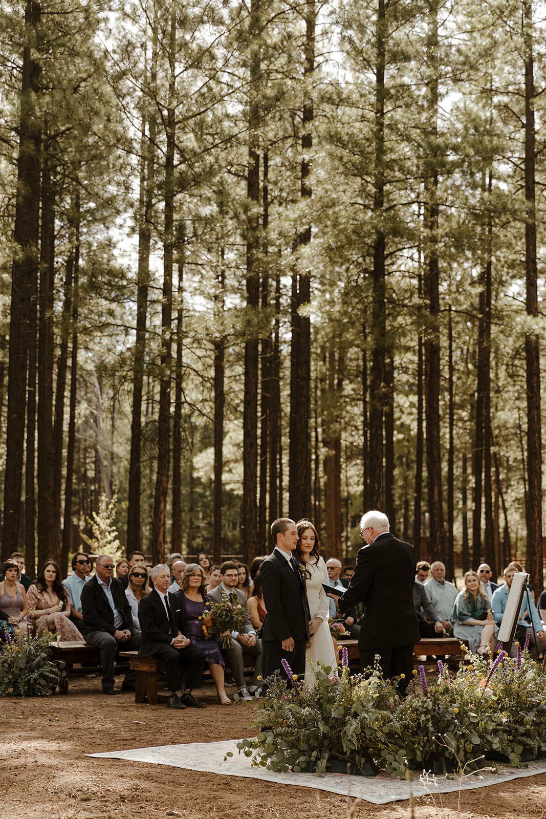 bride and groom at the altar of beautiful forest wedding 