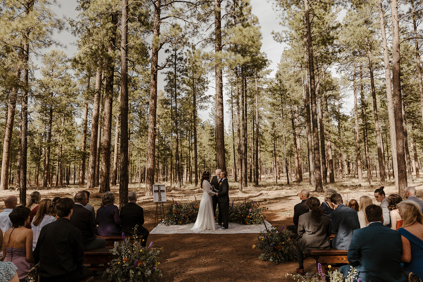 bride and groom at the altar of beautiful forest wedding 