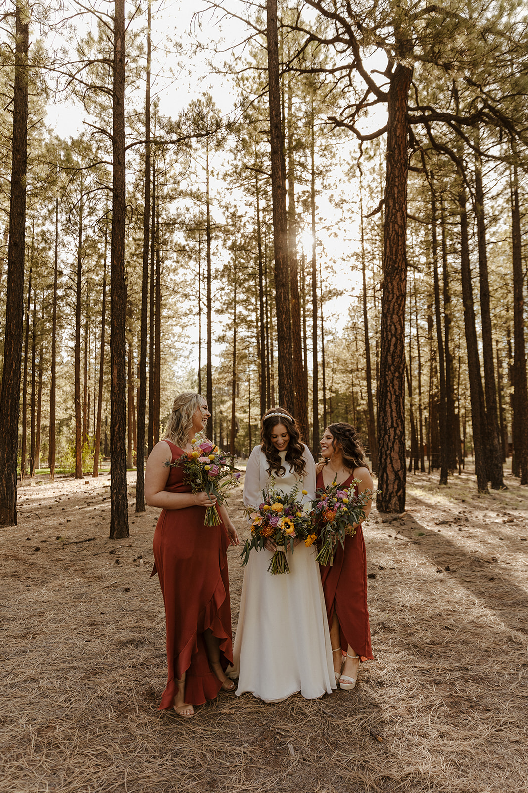 bride and bridesmaids in the woods