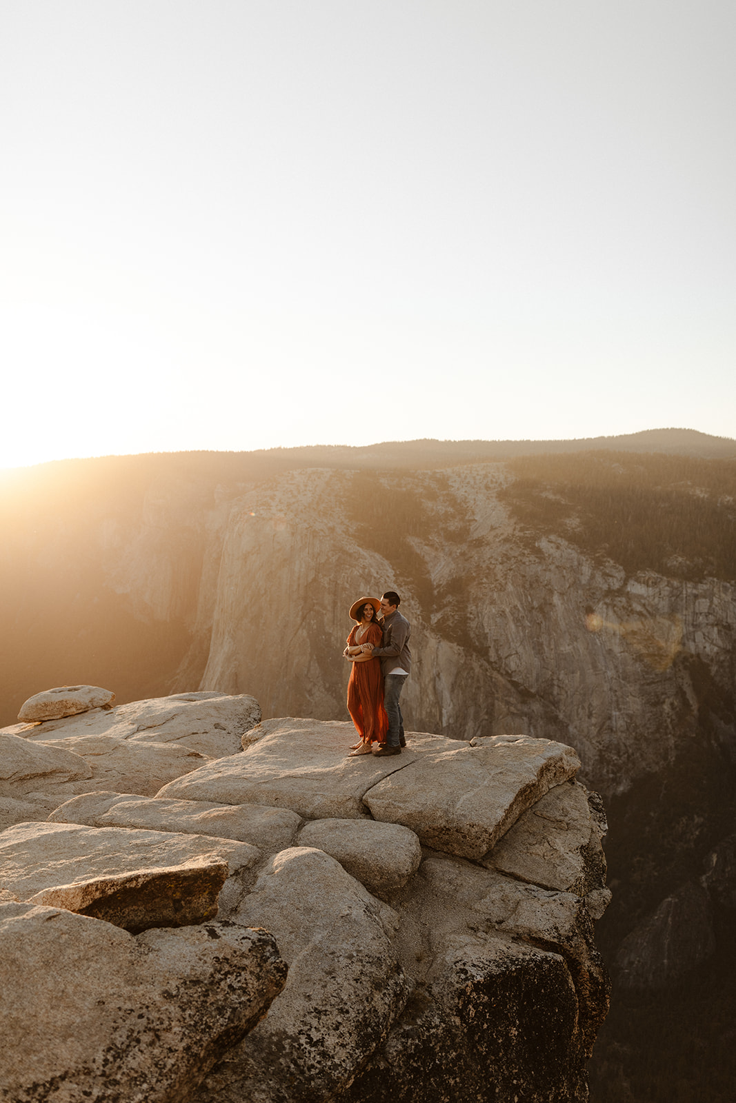 couple holding each other on top of Taft Point in Yosemite Park