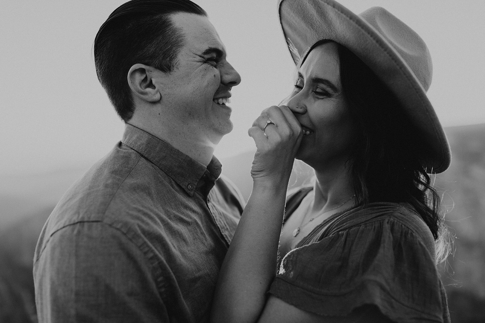 black and white of couple laughing 