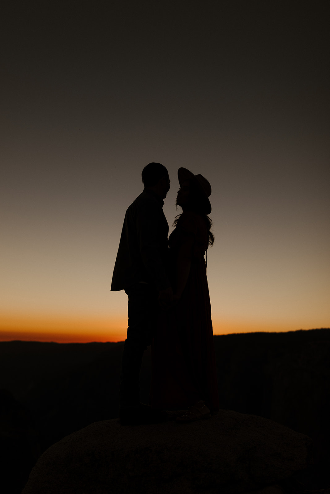 silhouettes of the couple at night with the last parts of sunset 