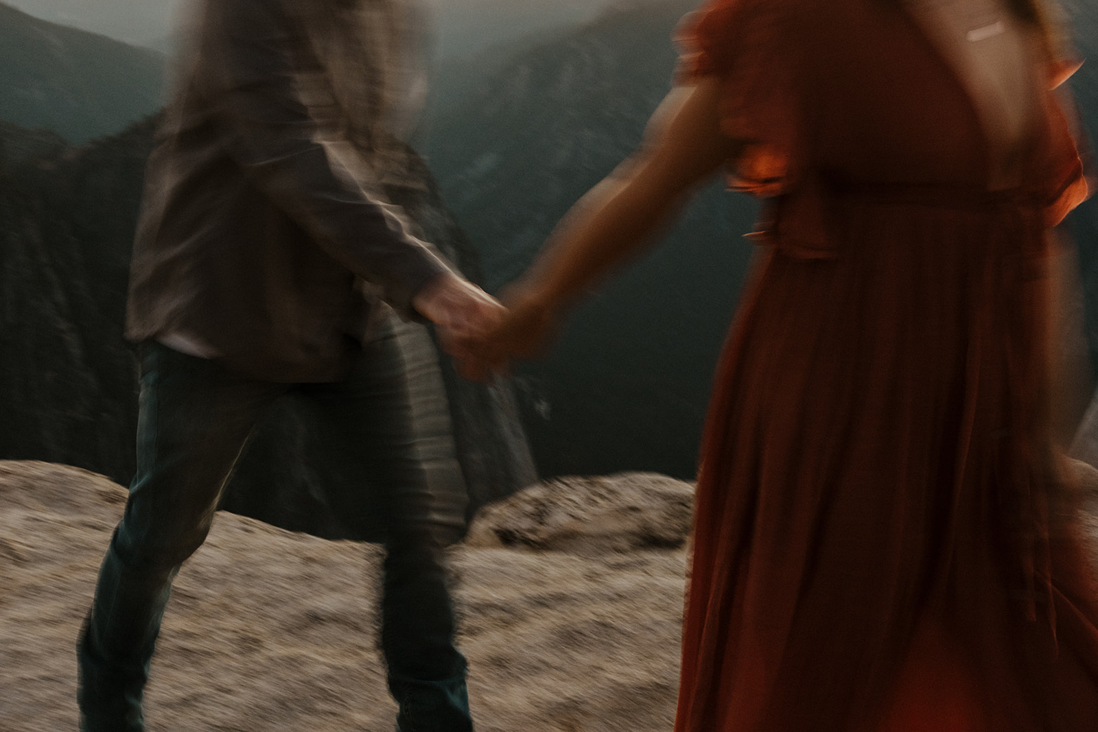burred photo of couple walking and holding hands 