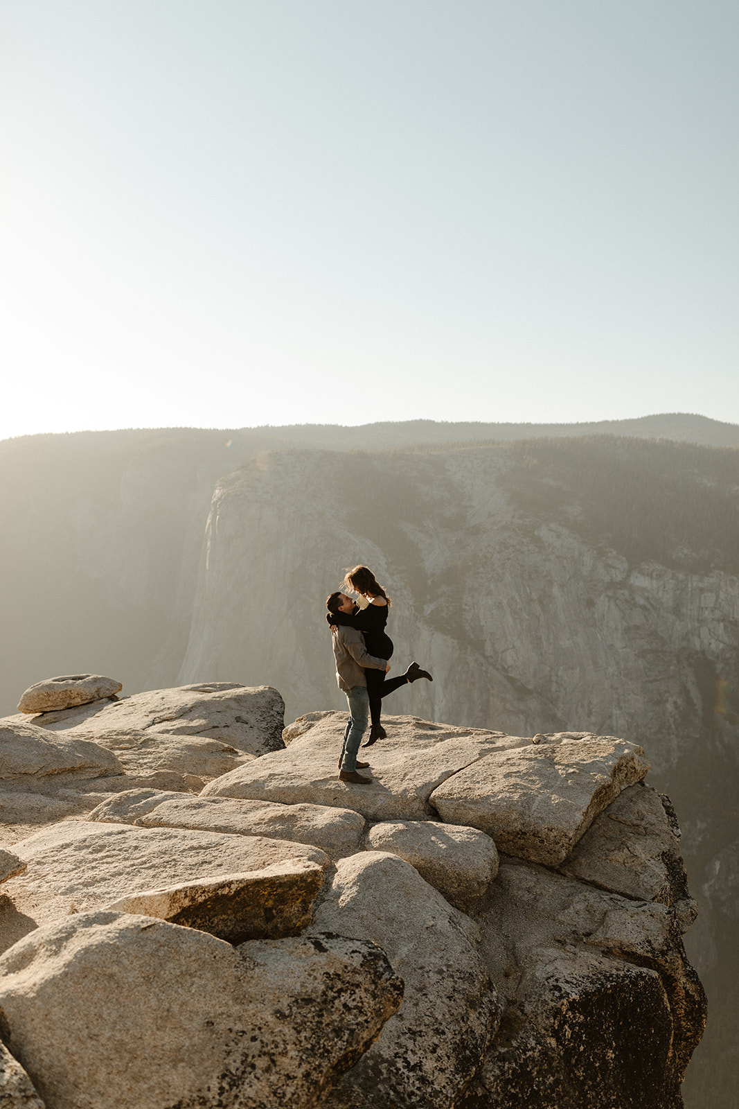 couple holding each other on Taft Point in Yosemite Park