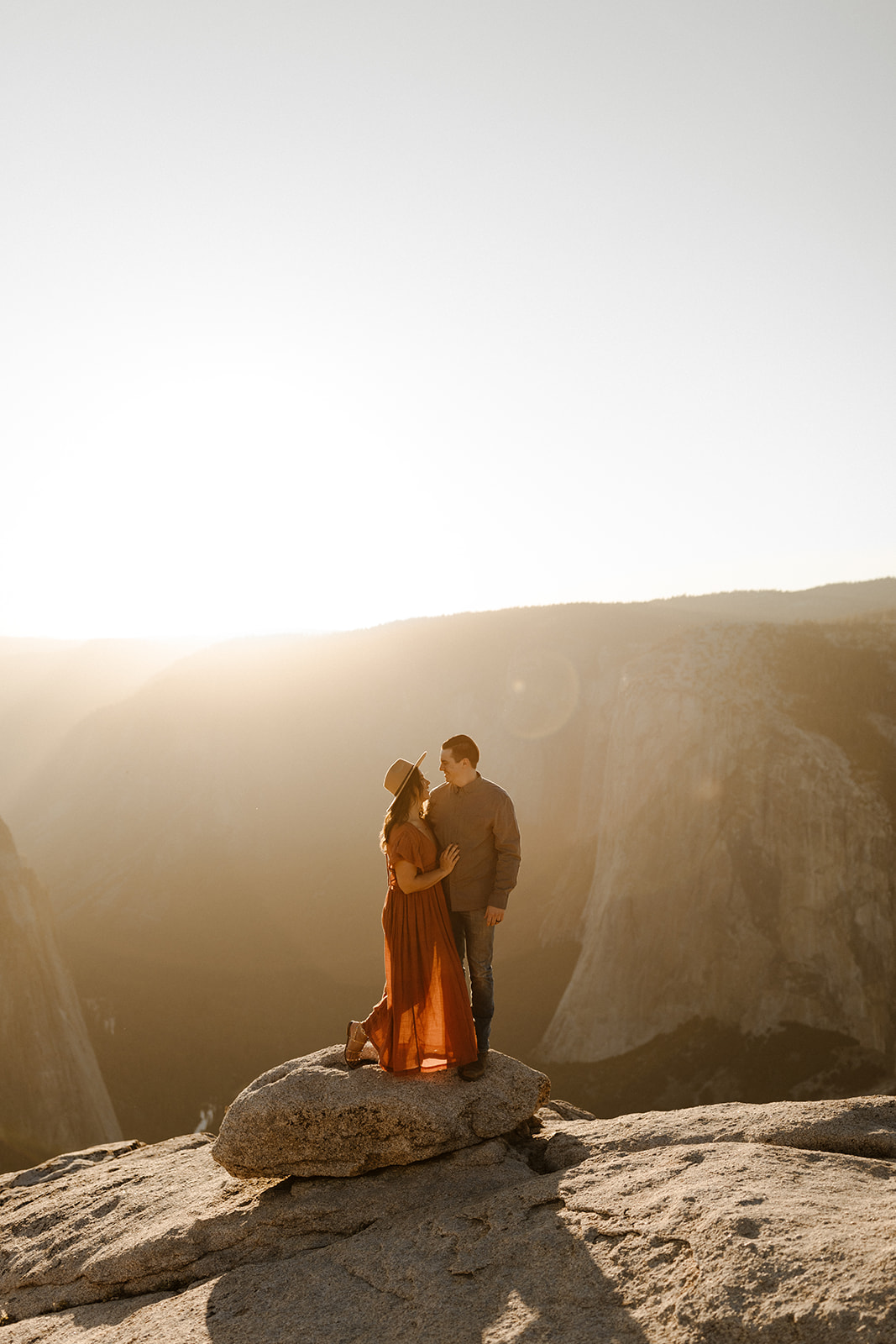 couple holding each other on top of Taft Point in Yosemite Park