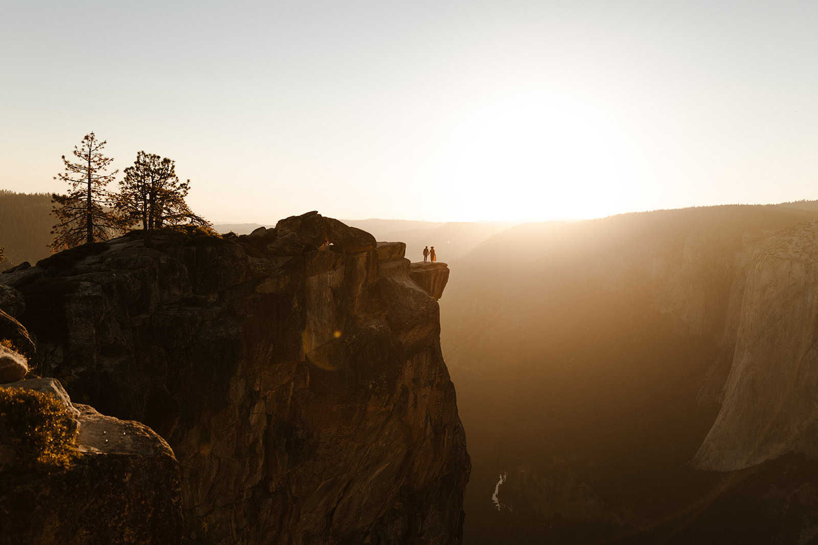 far away shot of couple on top of taft point in yosemite national park 
