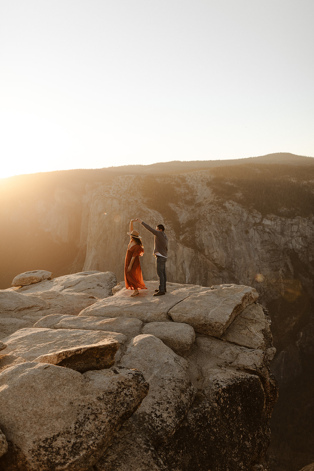 couple dancing on top of Taft Point in Yosemite
