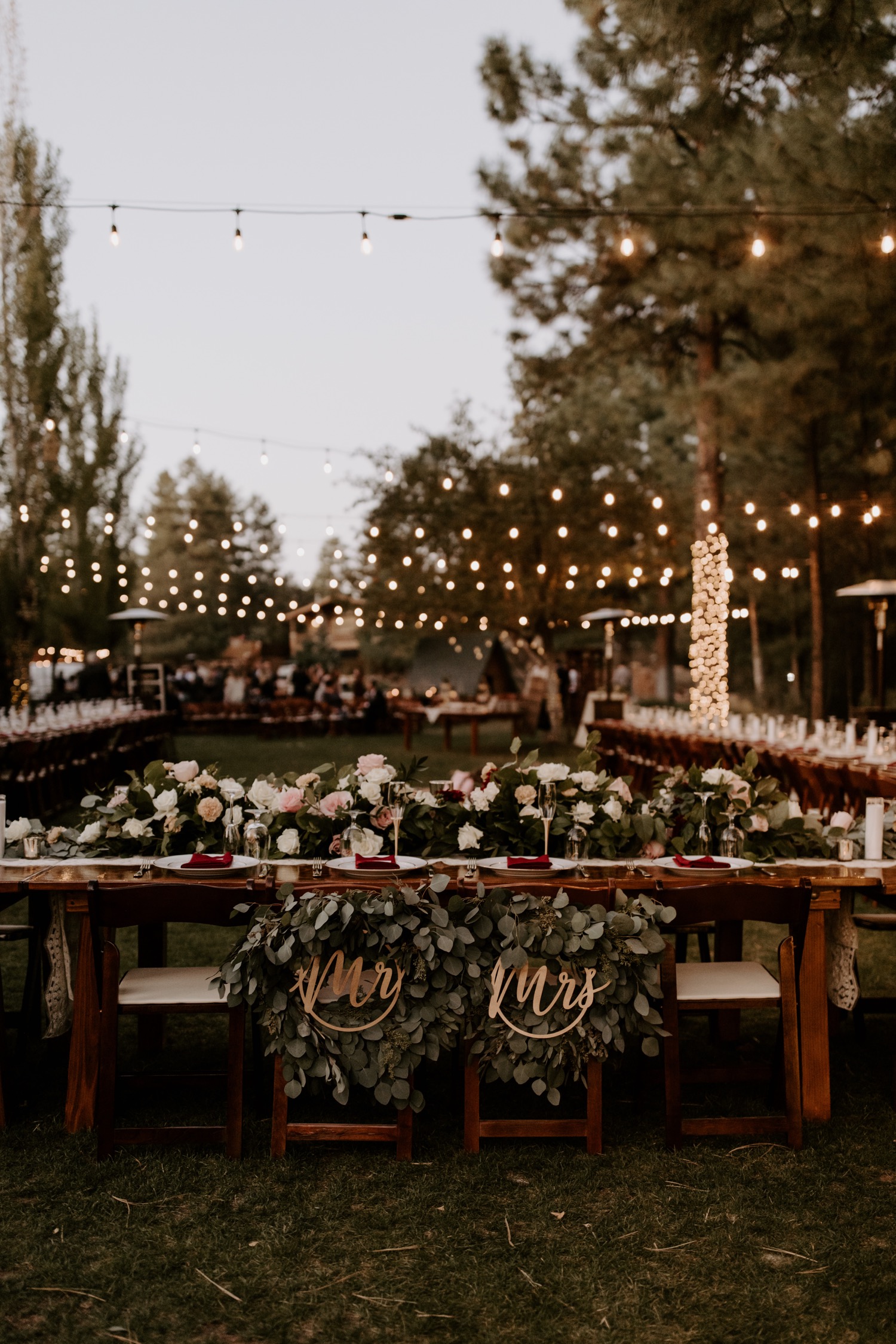 lighted outdoor reception decorations in the woods