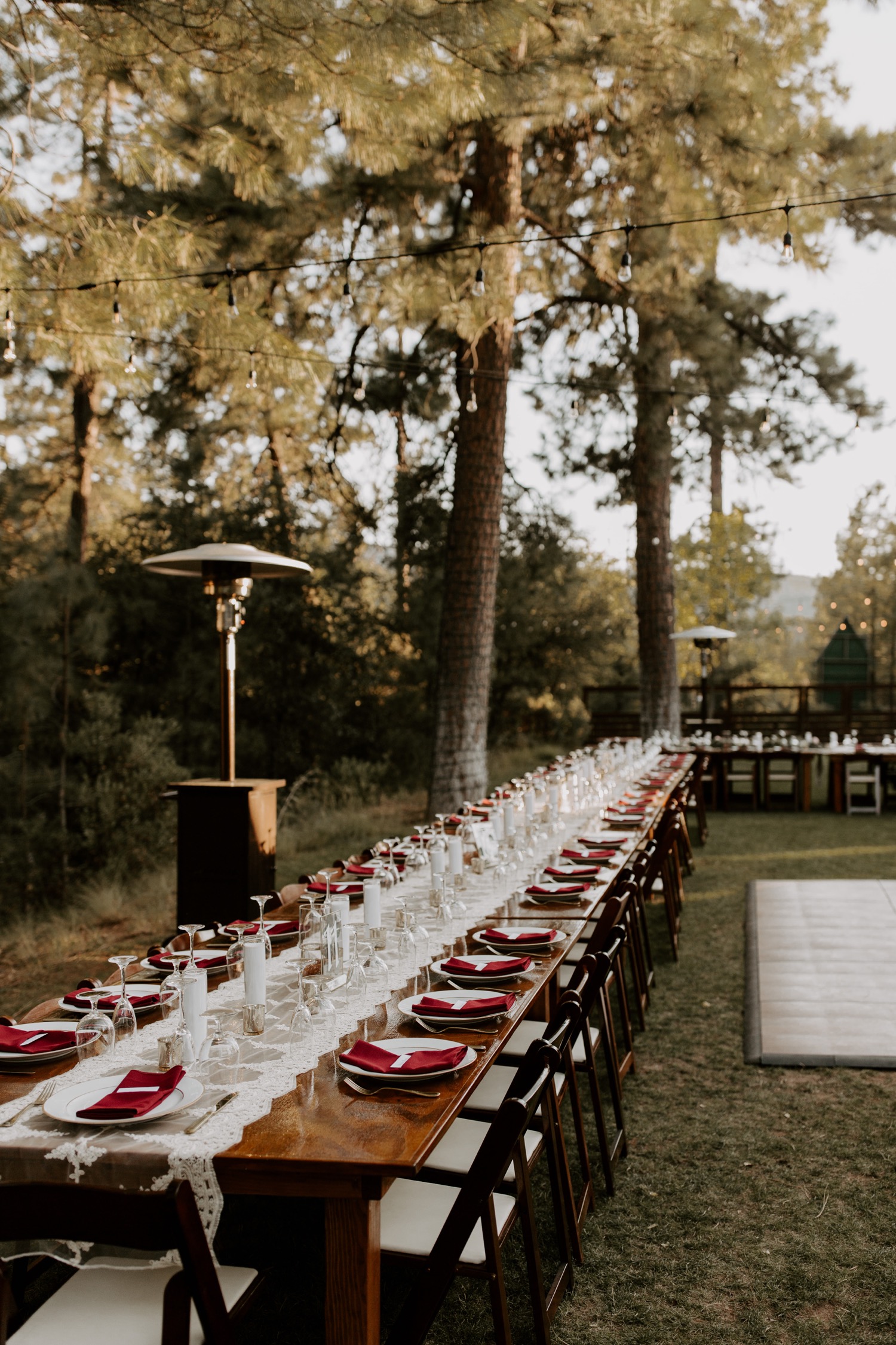 long decorated reception table in the woods