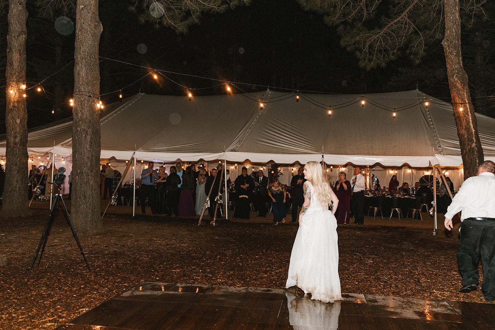 bride and guests on dance floor at night at one of Arizona's forest wedding venues